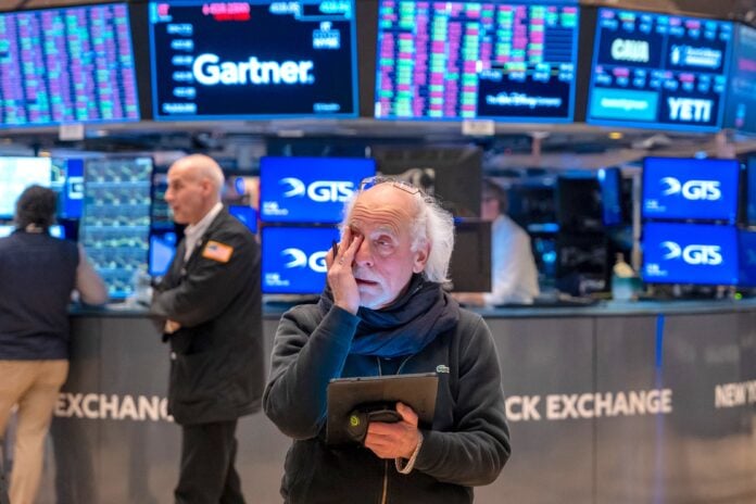 Traders on the floor of the New York Stock Exchange in a file photo as a global tech selloff nears Wall Street's open