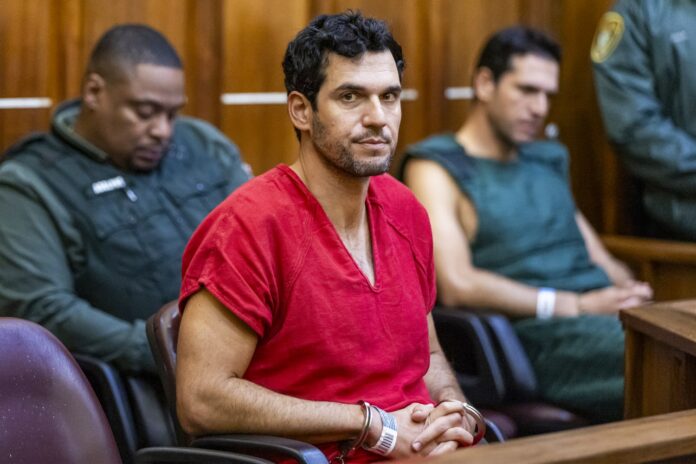 Oren Alexander in a red jail uniform and handcuffs at his bond hearing in a Miami courtroom in December 2024