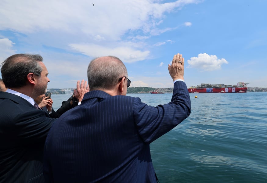 President Erdogan waves at the Osman Gazi floating gas platform as it passes through the Istanbul Strait
