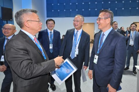 Hong Kong Financial Secretary Paul Chan laughing with HKMA chief Eddie Yue and IMF Deputy Managing Director Bo Li at the IMF-World Bank annual meetings in Bangkok