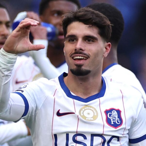 Chelsea forward Pedro Neto raises a hand in celebration after scoring at Everton