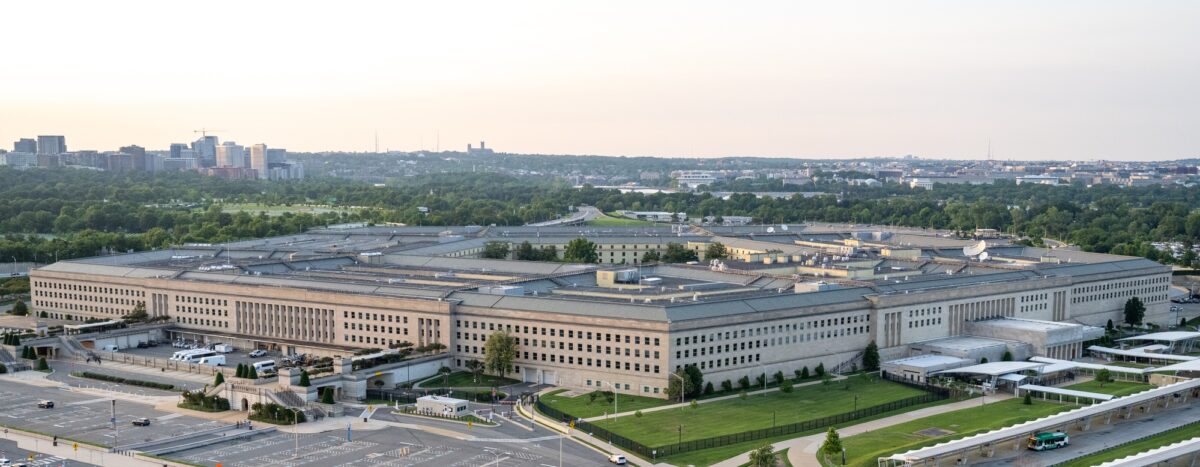 Aerial view of the Pentagon building in Washington, D.C., with the surrounding grounds and city skyline