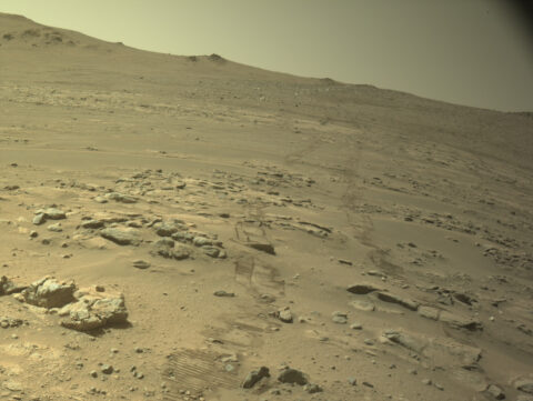 Rover tracks crossing a rocky slope on the western rim of Jezero Crater, seen by Perseverance's navigation camera