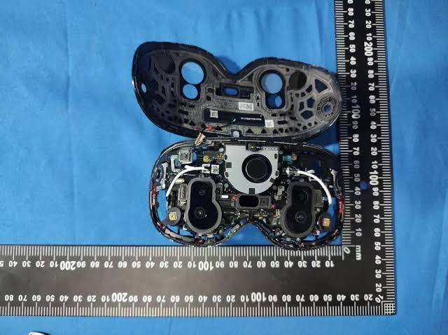 Disassembled Pico Space Pro headset components on a blue surface beside a ruler
