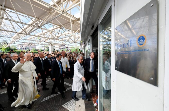 Pope Leo XIV waves as he walks into Gemelli Hospital in Rome