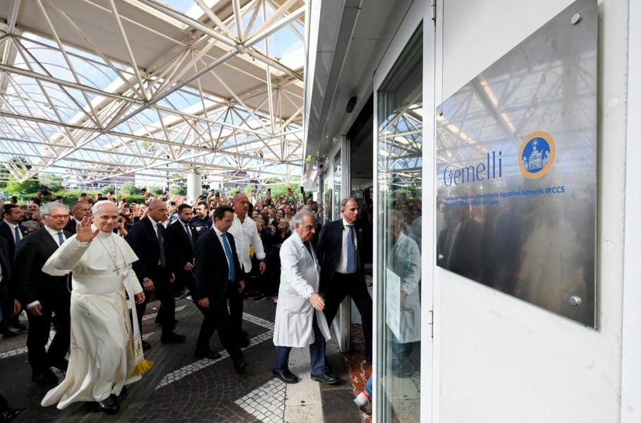 Pope Leo XIV waves as he walks into Gemelli Hospital in Rome