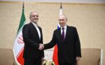 Vladimir Putin and Iranian President Masoud Pezeshkian shake hands in front of Russian and Iranian flags in Turkmenbashi