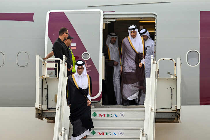 Gulf-dressed officials descend the steps of a plane at Beirut airport as Qatar's prime minister arrives for talks