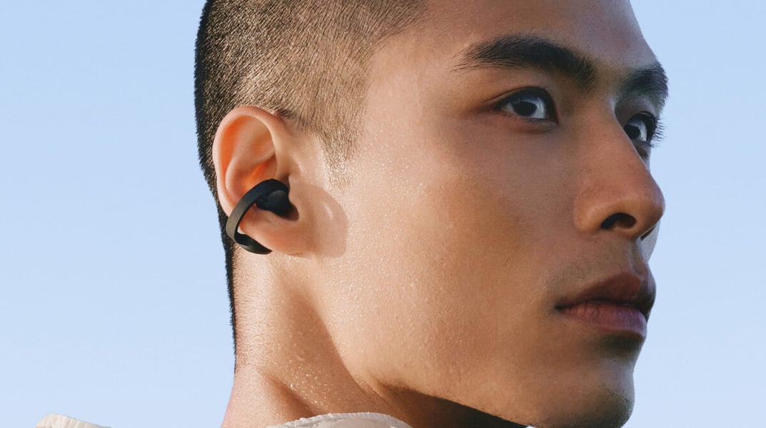Close-up of a black Galaxy Buds On earbud clipped around a person's ear