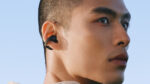 Close-up of a black Galaxy Buds On earbud clipped around a person's ear