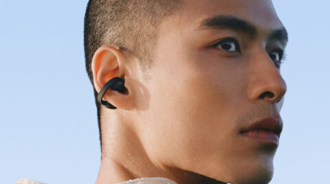 Close-up of a black Galaxy Buds On earbud clipped around a person's ear