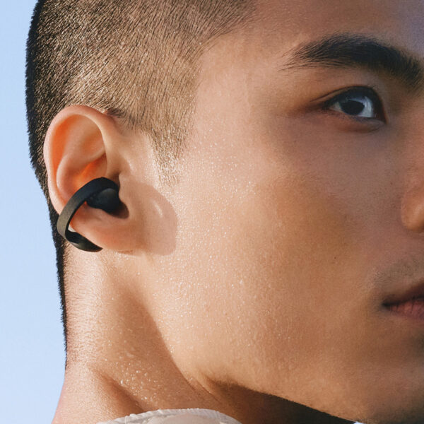 Close-up of a black Galaxy Buds On earbud clipped around a person's ear