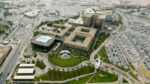 Aerial view of the Saudi Aramco headquarters complex in Dhahran with large buildings and car parks