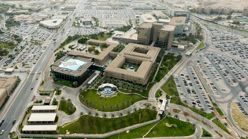 Aerial view of the Saudi Aramco headquarters complex in Dhahran with large buildings and car parks