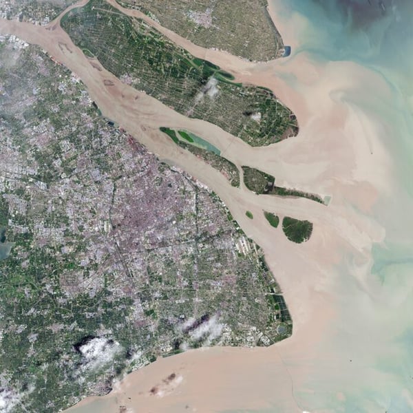 Satellite view of Shanghai and the Yangtze River delta with the city's urban area on the left and the river mouth opening to the sea