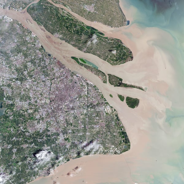 Satellite view of Shanghai and the Yangtze River delta with the city's urban area on the left and the river mouth opening to the sea