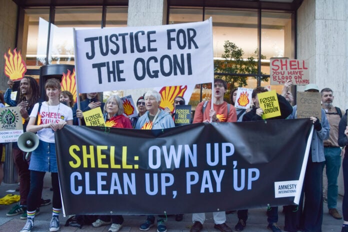 Protesters with Justice for the Ogoni banners outside Shell's headquarters in London
