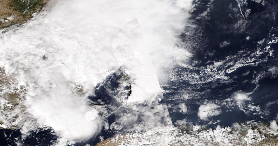 Satellite image of thick white cloud covering eastern Spain and the sea off its coast, with clear sea to the east