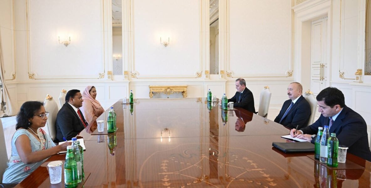 Sri Lanka's delegation led by Foreign Minister Vijitha Herath and Azerbaijan's President Ilham Aliyev seated at a long table in Baku