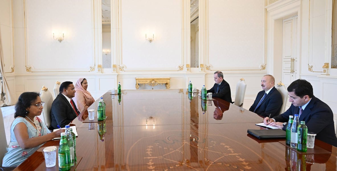 Sri Lanka's delegation led by Foreign Minister Vijitha Herath and Azerbaijan's President Ilham Aliyev seated at a long table in Baku