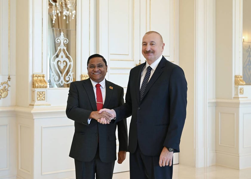 Sri Lanka's Foreign Minister Vijitha Herath shakes hands with Azerbaijan's President Ilham Aliyev in Baku