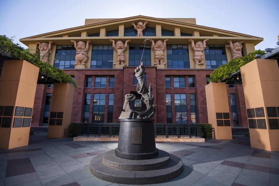 The Team Disney Building with its Seven Dwarfs sculptures and the Sorcerer Mickey statue in front