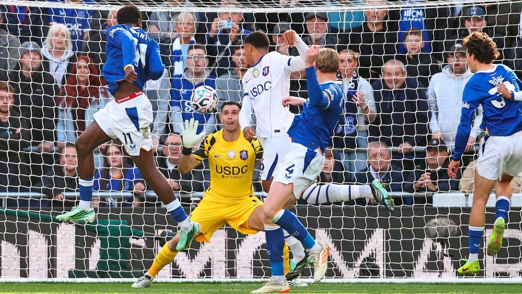 Everton striker Thierno Barry leaps to head the ball towards Chelsea goalkeeper Emiliano Martinez