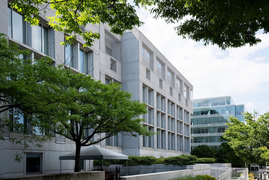 Granite facade of the Thurgood Marshall Federal Judiciary Building seen through trees in Washington