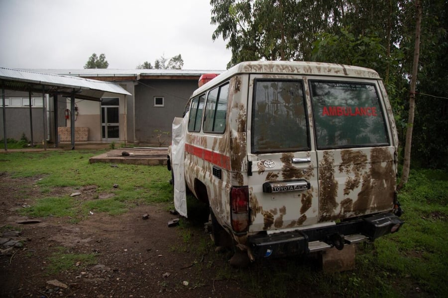 A mud-covered ambulance is parked outside a health centre in Gijet, Tigray, Ethiopia