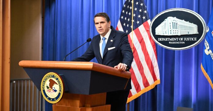 Todd Blanche speaking at a Justice Department podium during the January 30, 2026, Epstein files briefing