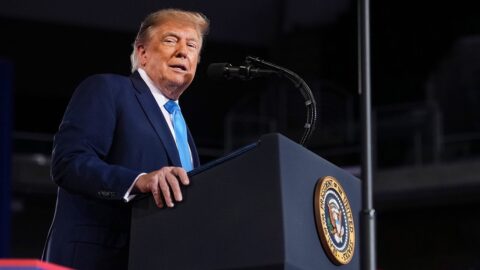 President Donald Trump speaking at a podium bearing the presidential seal during a midterm rally in Highland Heights, Kentucky