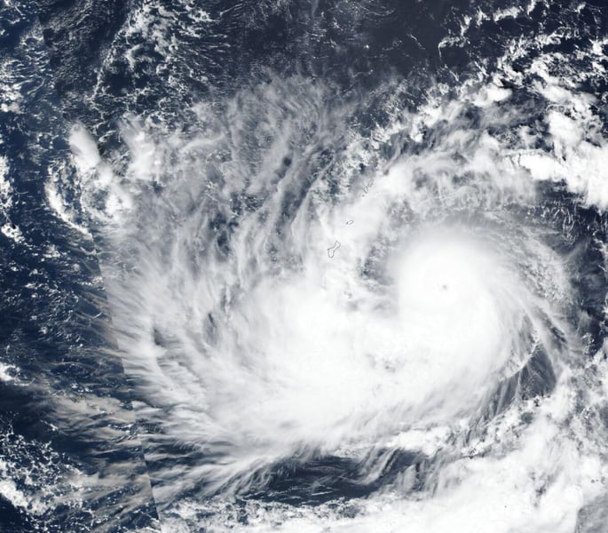 Satellite view of Typhoon Champi with a clear eye to the east-southeast of Guam, whose outlined coastline sits to the left of the eye