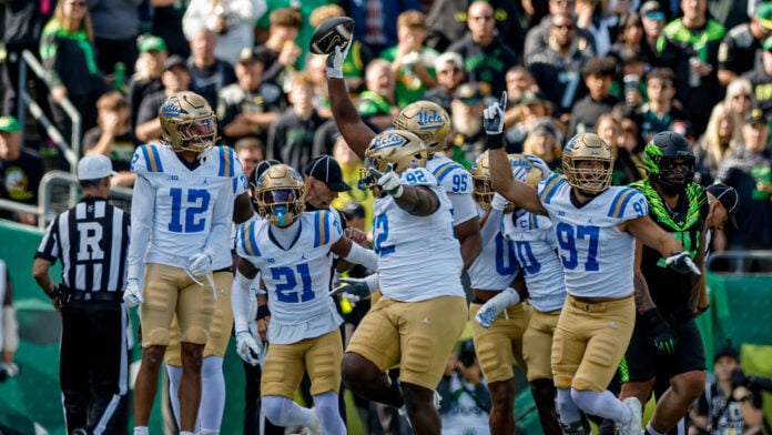 UCLA defenders celebrate a fumble recovery against Oregon