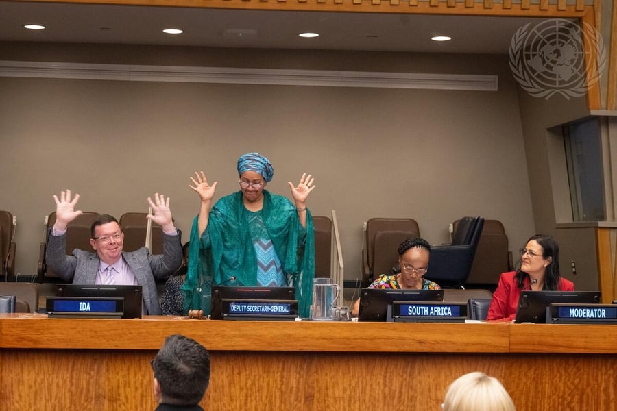 Background photograph from a United Nations disability-inclusion event