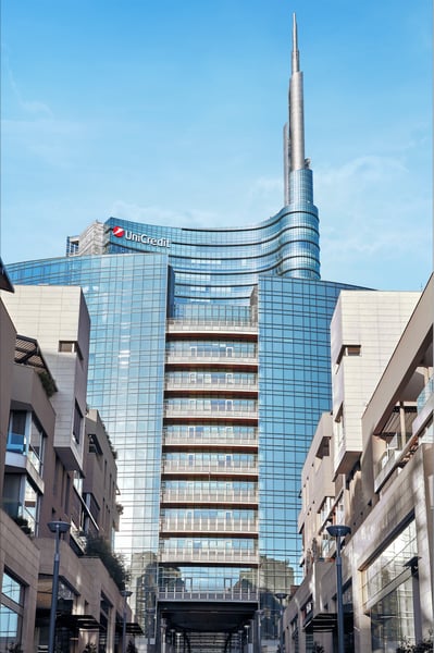 UniCredit headquarters tower with the bank's logo rising above buildings at Piazza Gae Aulenti in Milan