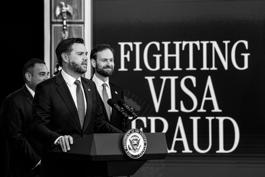 Vice President JD Vance speaks at a lectern with the vice presidential seal in front of a screen reading Fighting Visa Fraud