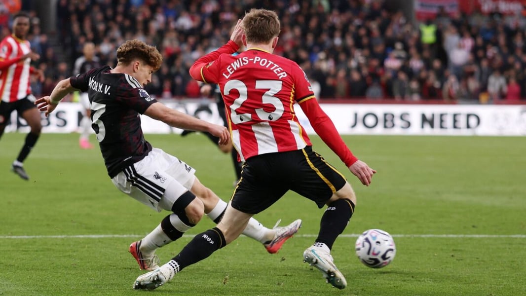Liverpool's Victor Munoz strikes the ball past Brentford's Keane Lewis-Potter during the Premier League match at Brentford