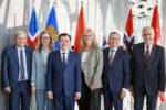 Six Viet Nam and EFTA ministers stand side by side in front of national flags in Reykjavik