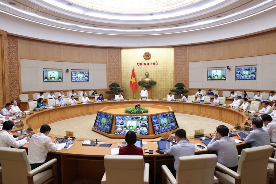 Vietnamese ministers seated around the circular table of the Government meeting room in Hanoi during the regular cabinet meeting