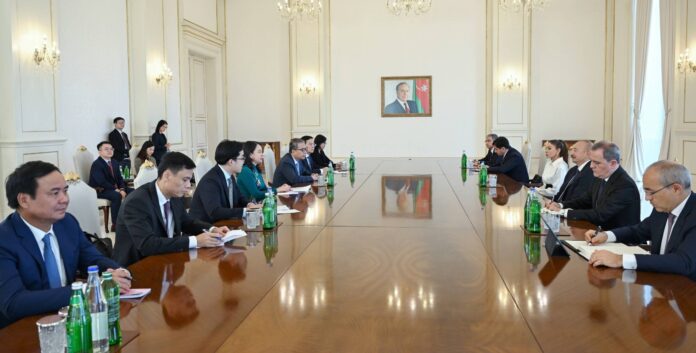 Vietnam's Vice President Vo Thi Anh Xuan and Azerbaijan's President Ilham Aliyev with their delegations at a long table in Baku