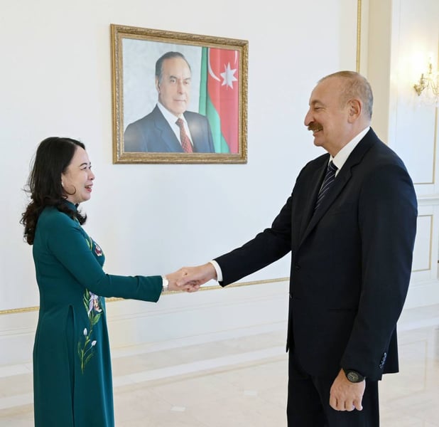 Vietnam's Vice President Vo Thi Anh Xuan shakes hands with Azerbaijan's President Ilham Aliyev in Baku