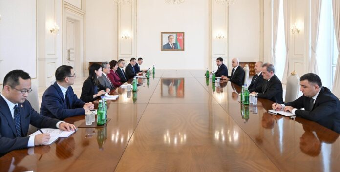 Delegations of China and Azerbaijan seated along a long table during Wang Yi's meeting with President Ilham Aliyev in Baku