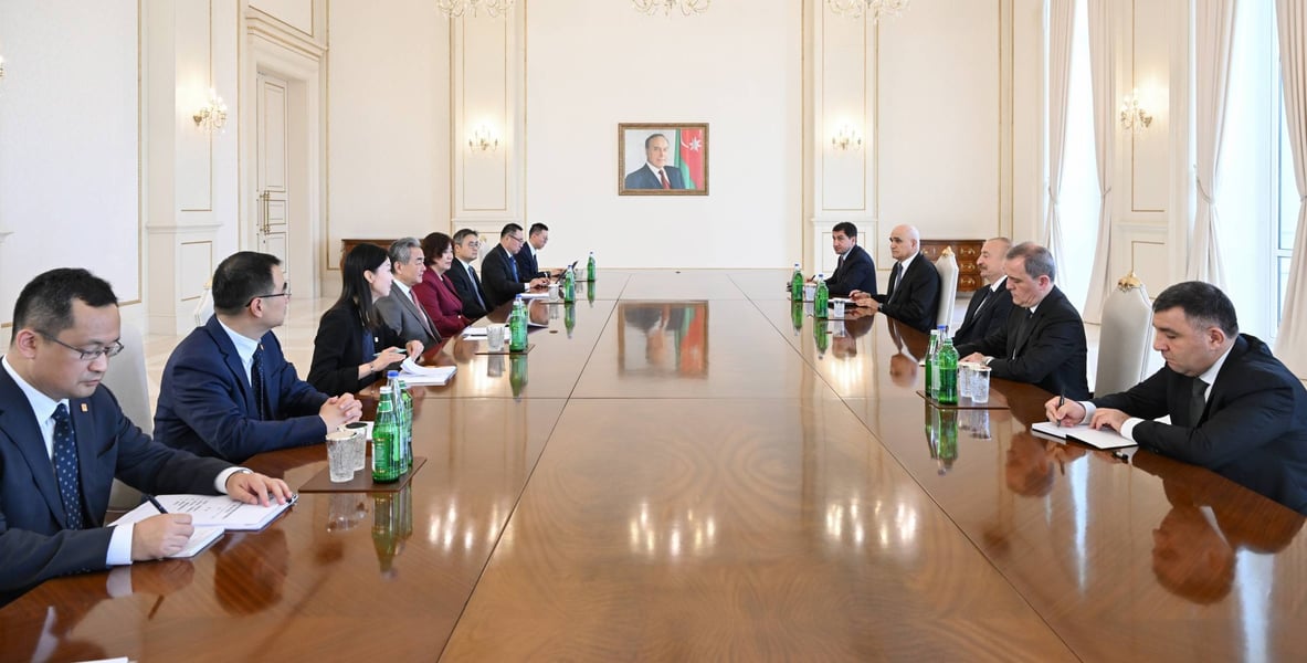 Delegations of China and Azerbaijan seated along a long table during Wang Yi's meeting with President Ilham Aliyev in Baku