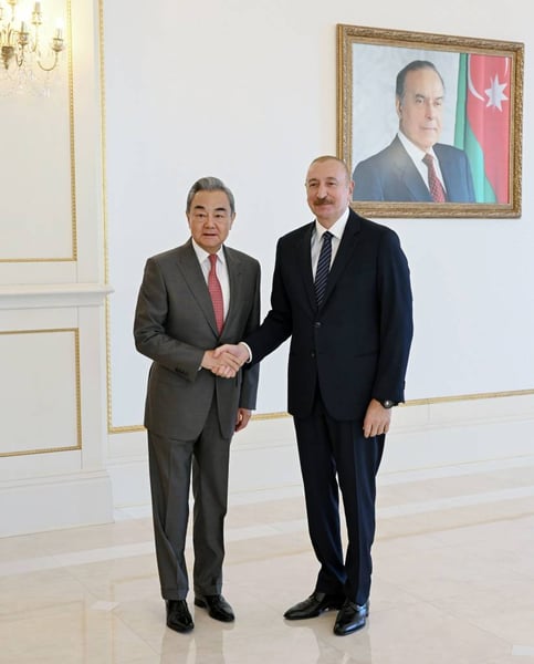 China's Foreign Minister Wang Yi shakes hands with Azerbaijan's President Ilham Aliyev in Baku