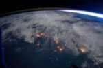 Night view from the International Space Station of lightning, clouds and city lights along the central west coast of Africa