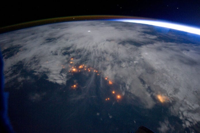Night view from the International Space Station of lightning, clouds and city lights along the central west coast of Africa