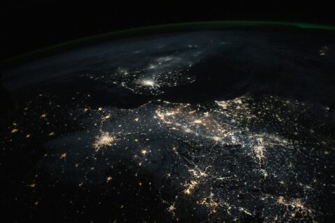 City lights of Paris, Amsterdam and London glowing against the dark English Channel and North Sea, seen from orbit