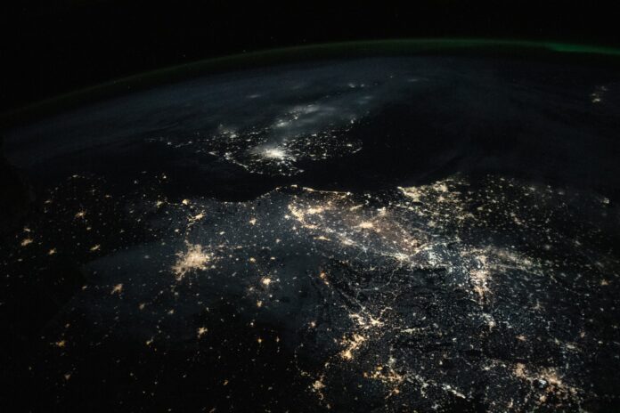 City lights of Paris, Amsterdam and London glowing against the dark English Channel and North Sea, seen from orbit