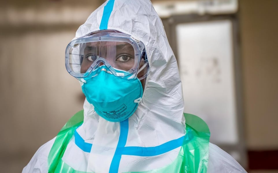 Health worker in a white protective suit, goggles and a teal mask during the Ebola response in Kenya