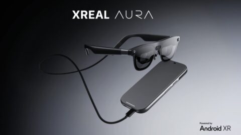 Black Xreal Aura glasses connected by a cable to a rectangular companion device